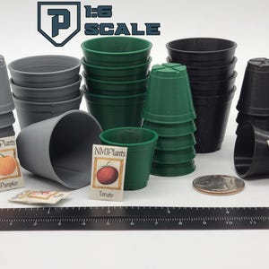 May include: An assortment of miniature gray, green, and black plant pots, with seed packets and a ruler. The seed packets feature illustrations of a pumpkin, tomato, and peppers. The image also includes a quarter for scale.