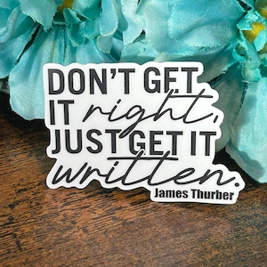 May include: White sticker with black text that reads "Don't get it right, just get it written."  The text is in a handwritten font.  The sticker also includes the name "James Thurber" in smaller text below the quote.