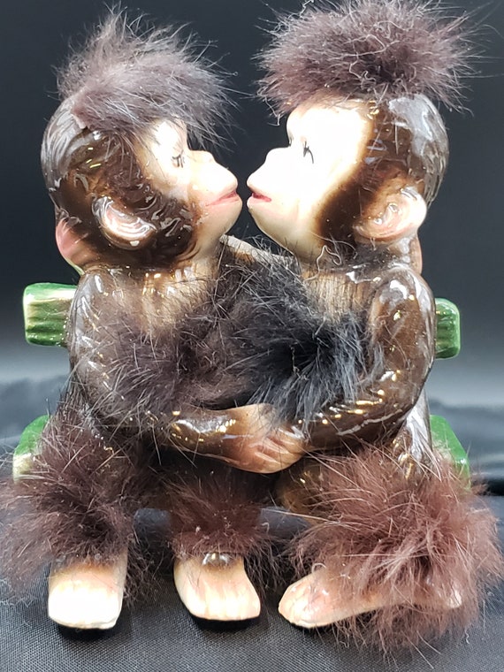 Monkeys in Love and Kissing on a Bench With Fur Trim by Bradley