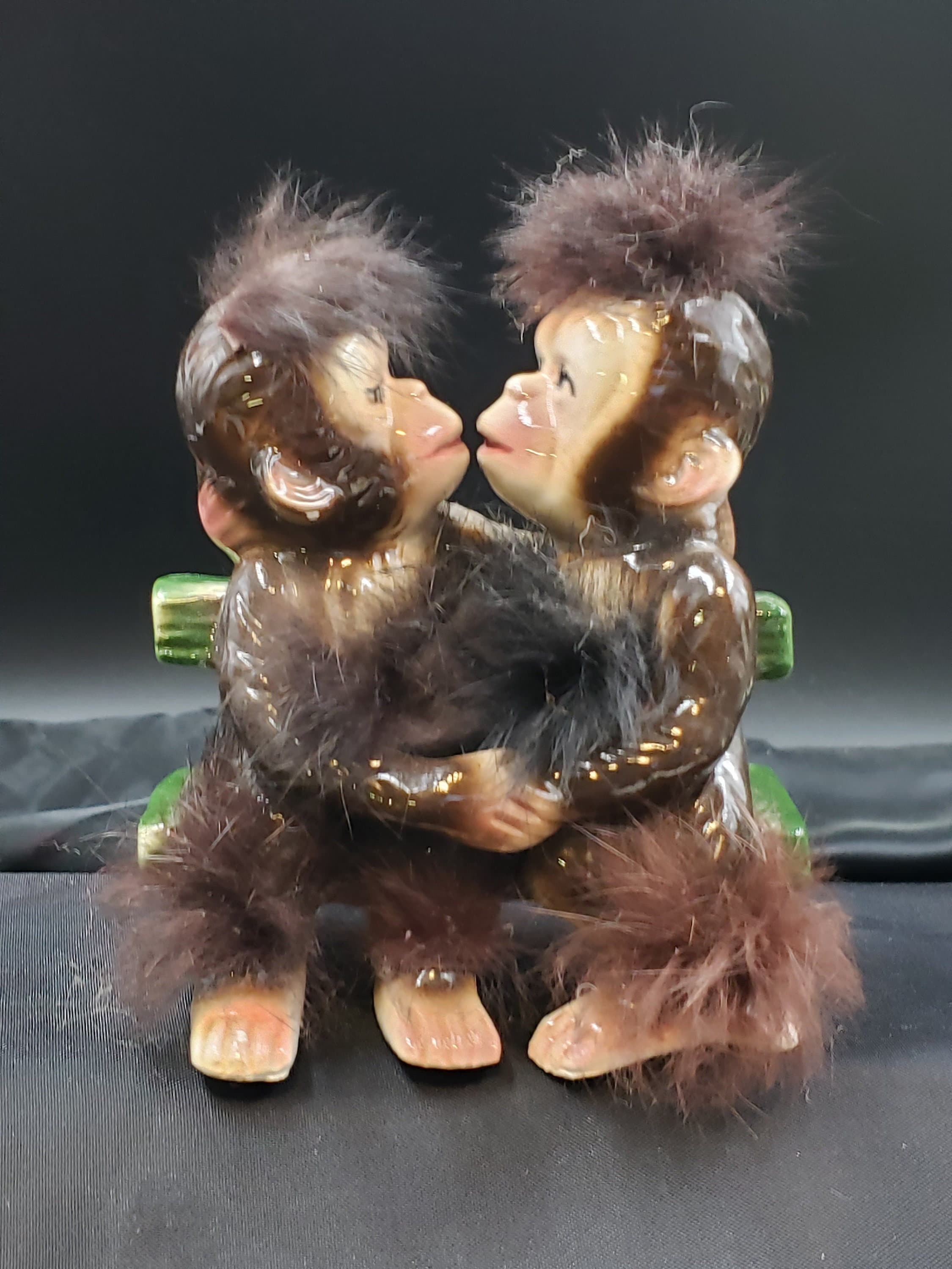 Monkeys in Love and Kissing on a Bench With Fur Trim by Bradley
