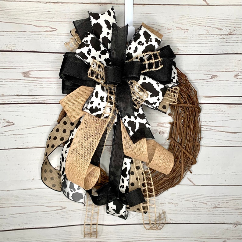 Black and White Cow Bow on an eighteen inch wreath with a distressed wood photography background.  The Grapevine wreath is for display only and not for sale. Refer to the listing description for further bow details.