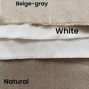May include: Three fabric swatches in beige-gray, white, and natural colors. The swatches are lined up horizontally, with the beige-gray swatch on top, the white swatch in the middle, and the natural swatch on the bottom.