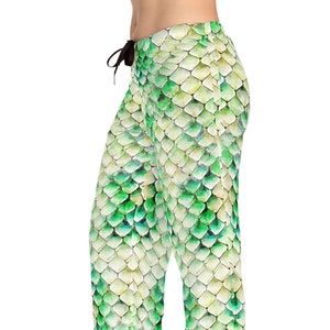 May include: Green pajama pants with a watercolor scale pattern. The pants have a drawstring waist and a loose fit. The scale pattern features shades of green and white.
