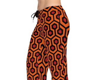 May include: Orange and black patterned pajama pants with a geometric design. The pants have a drawstring waist.