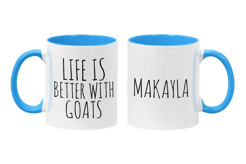 May include: Two white ceramic mugs with blue rims and handles. One mug says "Life is better with goats" and the other mug says "Makayla".