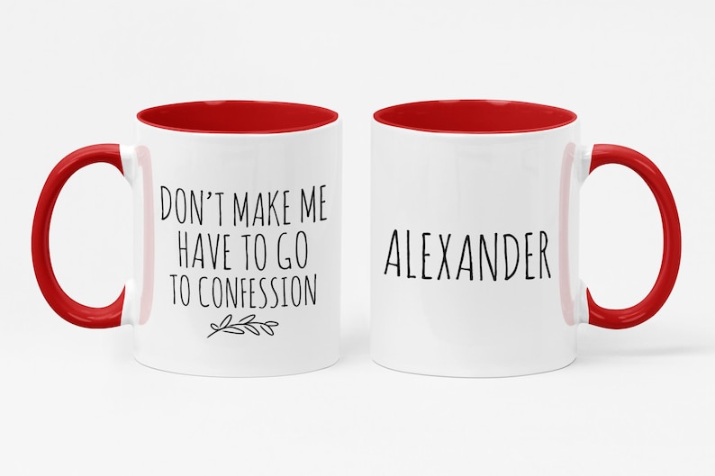 May include: Two white ceramic mugs with red interiors and handles. One mug has the text "DON'T MAKE ME HAVE TO GO TO CONFESSION" and a small leaf design. The other mug has the name "ALEXANDER" in black text.
