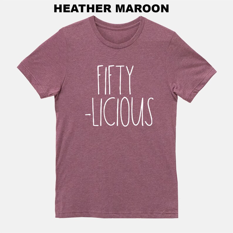 May include: Heather maroon t-shirt with white text that reads "Fifty -licious".