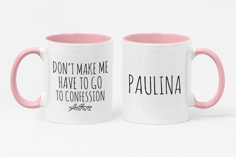 May include: Two white ceramic mugs with pink handles and interiors. One mug reads "DON'T MAKE ME HAVE TO GO TO CONFESSION" in black text, the other says "PAULINA". A simple, fun gift idea.