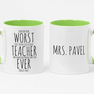 May include: White ceramic mug with a green handle and interior. The mug features the text "EVEN ON YOUR WORST DAYS, YOU'RE STILL A GREAT TEACHER" on one side and "MRS. PAVEL" on the other. A thoughtful gift for a teacher.