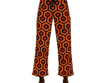 May include: Orange and black patterned pajama pants with a geometric design. The pants have a drawstring waist.
