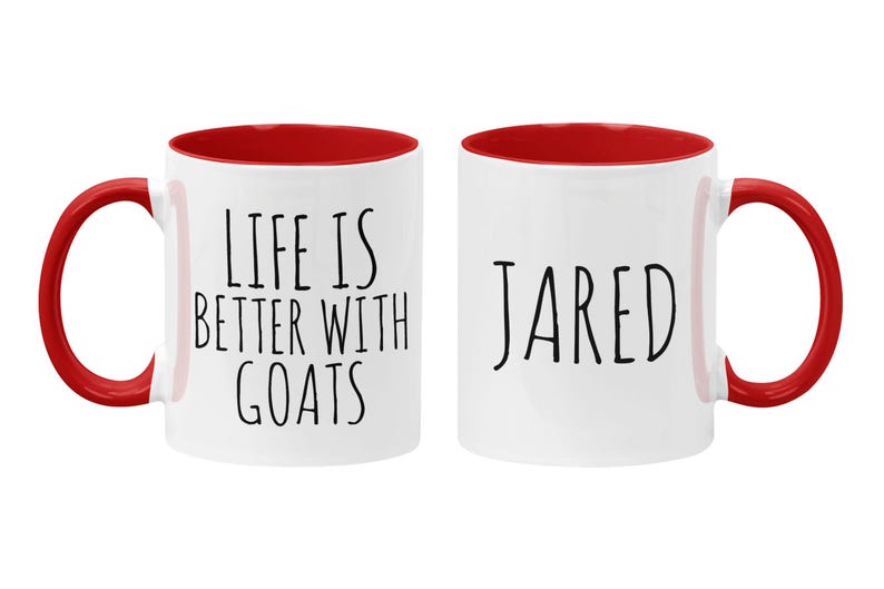 May include: Two white ceramic mugs with red interiors. One mug says "Life is better with goats" and the other mug says "JARED".