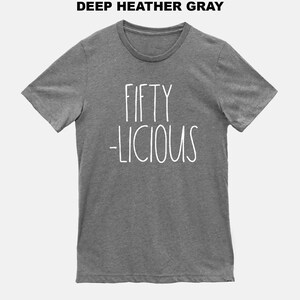May include: A heather gray t-shirt with the text "FIFTY -LICIOUS" printed in white.