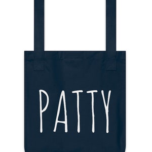 May include: A navy blue tote bag with white text that says "PATTY".