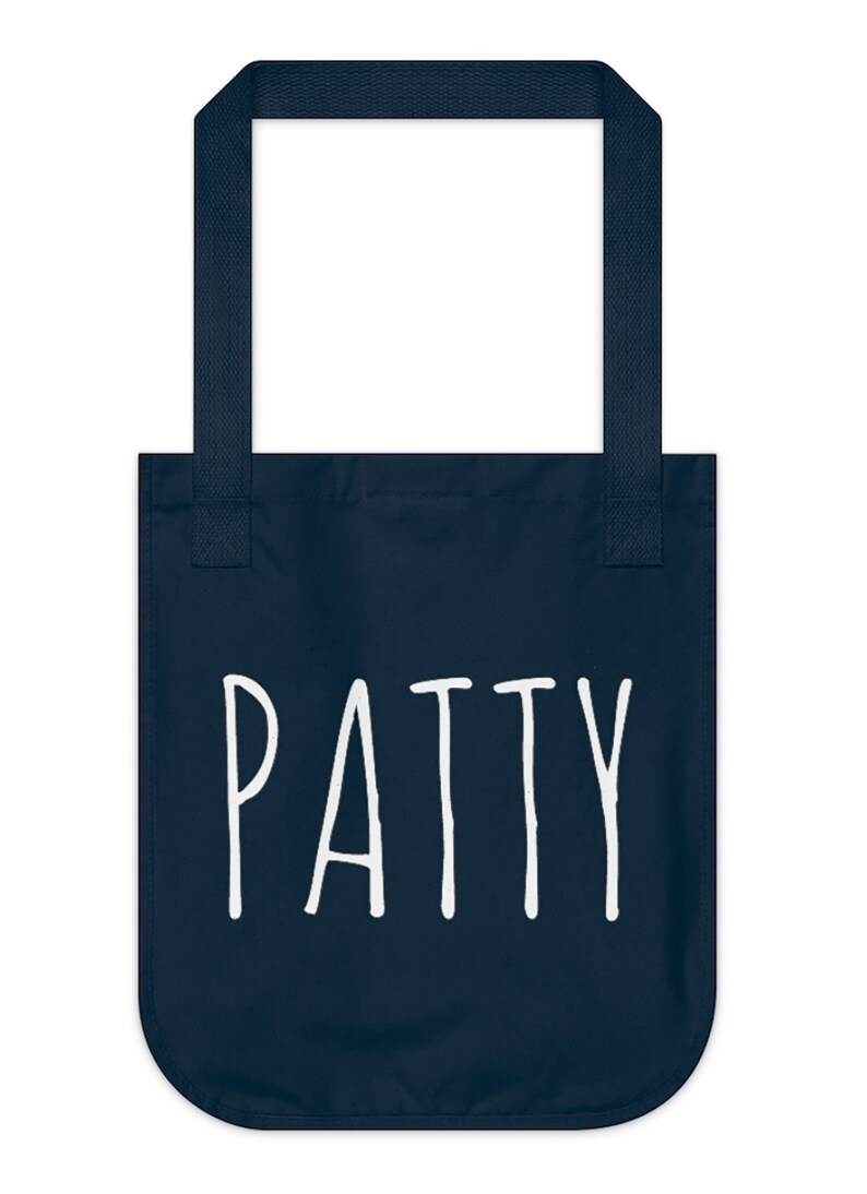 May include: A navy blue tote bag with white text that says "PATTY".