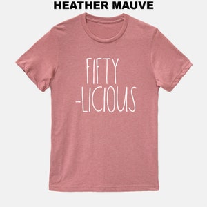May include: Heather mauve t-shirt with white text that reads "Fifty -licious".