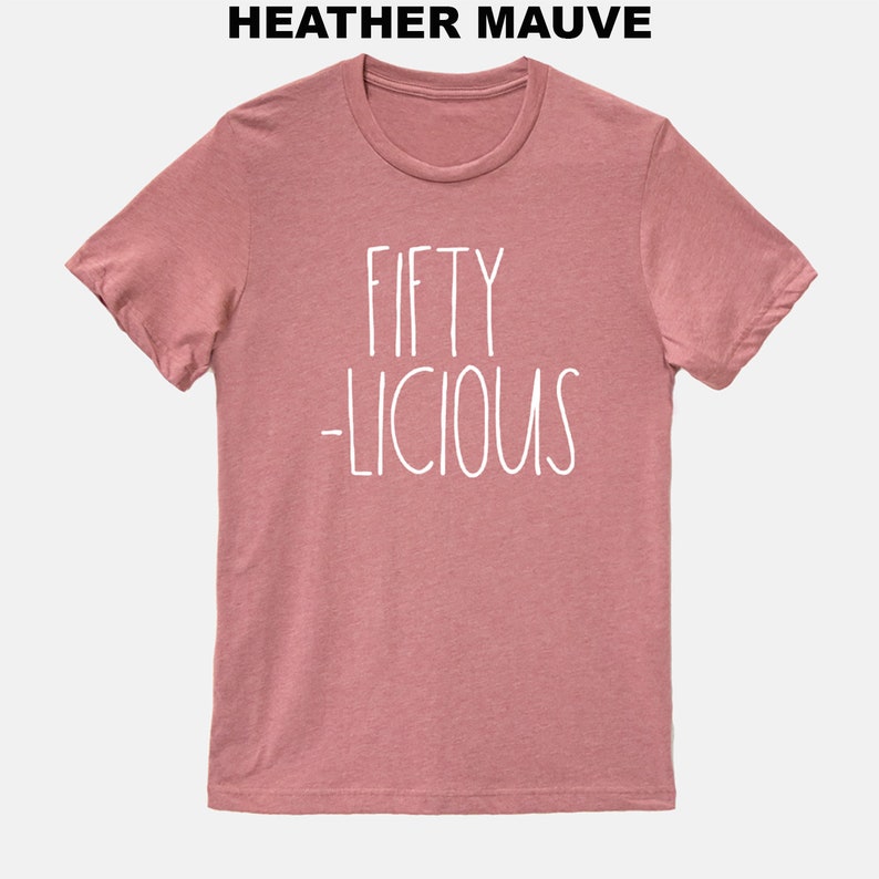 May include: Heather mauve t-shirt with white text that reads "Fifty -licious".