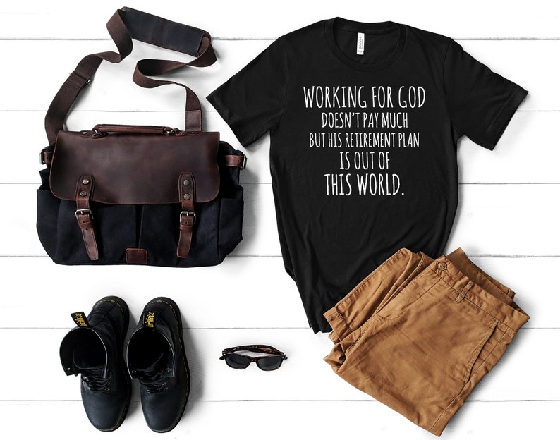 May include: Black t-shirt with white text that reads "Working for God doesn't pay much but his retirement plan is out of this world."