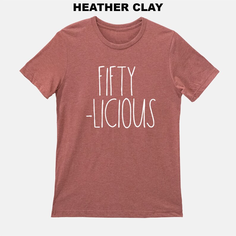 May include: A heather clay t-shirt with the text "FIFTY -LICIOUS" in white.