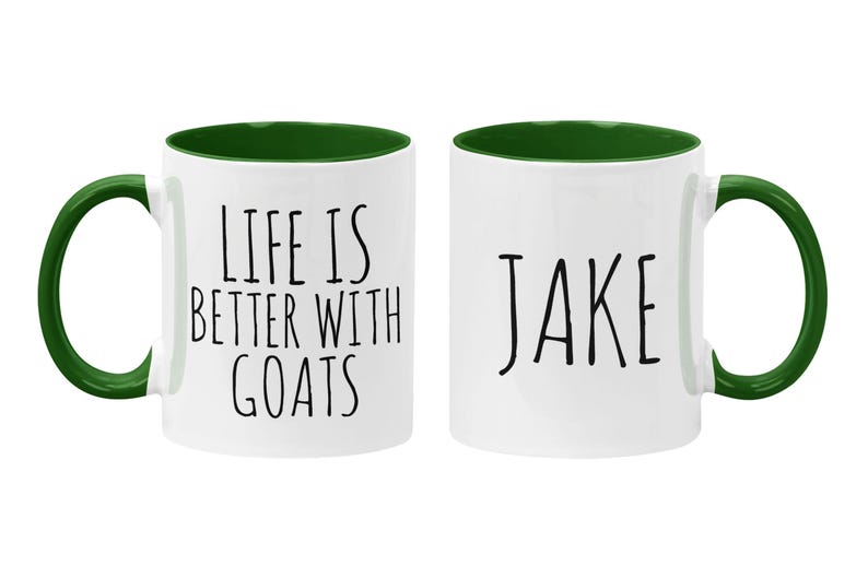 May include: Two white ceramic coffee mugs with green rims and handles. One mug says "Life is better with goats" and the other mug says "Jake".