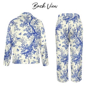 May include: A two-piece pyjama set with a blue and white toile pattern. The set includes a long-sleeved button-up shirt and matching trousers. The pattern depicts trees, birds, and butterflies. The words "Back View" are at the top of the image.