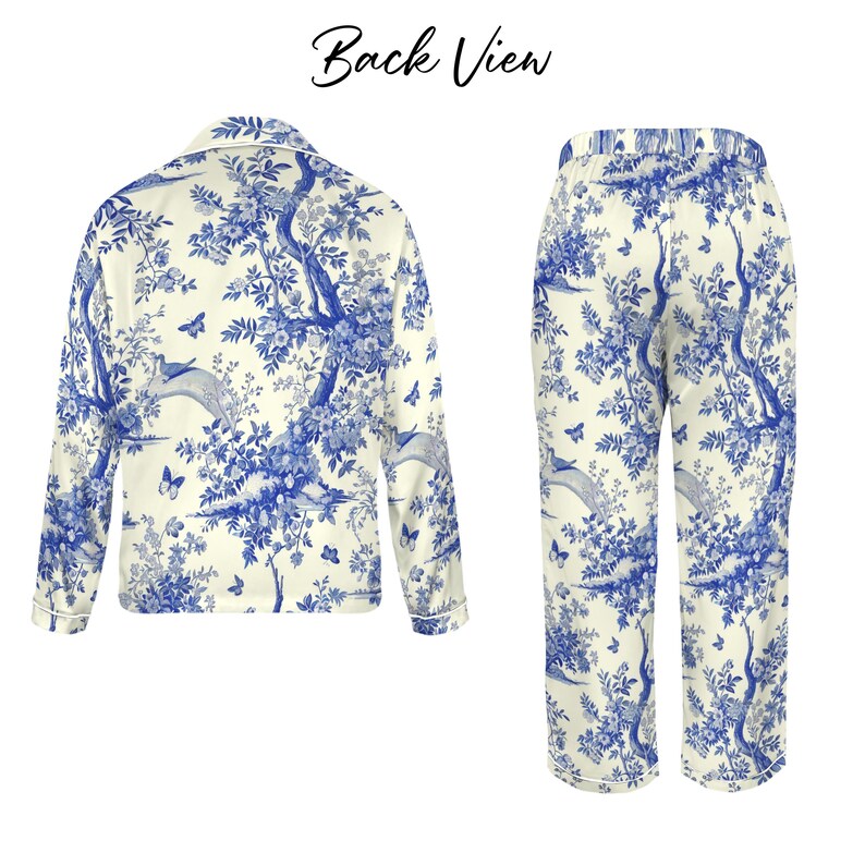 May include: A two-piece pyjama set with a blue and white toile pattern. The set includes a long-sleeved button-up shirt and matching trousers. The pattern depicts trees, birds, and butterflies. The words "Back View" are at the top of the image.