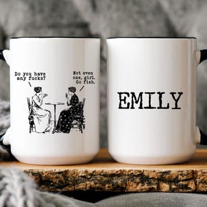 May include: White ceramic mug with a black handle and rim. One side features a vintage illustration with the text "Do you have any fucks?" and "Not even one, girl. Go fish." The other side displays the name "EMILY" in bold, black letters.