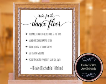 May include: A framed sign with gold trim and the text "rules for the dance floor." The sign lists dance floor rules, including "Dance-offs should happen often" and "Dad dancing welcome." The bottom of the sign says "#EllaAndMicahGotHitched."