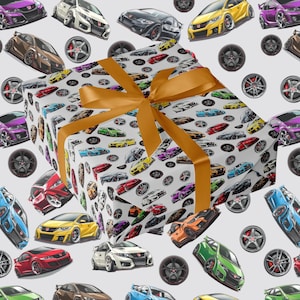 May include: A wrapped present with a gold ribbon, set against a backdrop of a pattern featuring colourful sports cars and wheels on a white surface. The cars are in various colours.