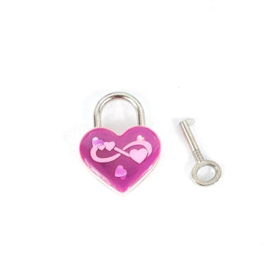 May include: A pink heart-shaped padlock with an infinity symbol and small hearts design. The padlock comes with a silver key.