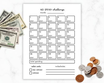 May include: A white "NO SPEND challenge" printable with a calendar layout for tracking expenses. Includes boxes for each day of the month, with spaces for notes and a color code. US currency and coins are visible.