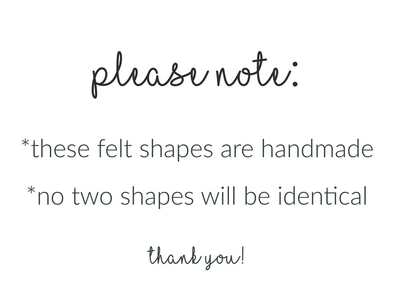May include: White background with black handwritten text that reads "please note: *these felt shapes are handmade *no two shapes will be identical thank you!"