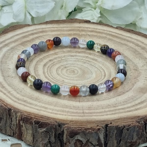 May include: A colorful beaded bracelet with a variety of stones, including amethyst, carnelian, clear quartz, and tiger's eye.