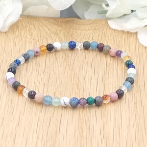 May include: A colorful beaded bracelet with a variety of stones, including blue, green, orange, and white.