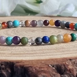 May include: A colorful beaded bracelet with various gemstones, including amethyst, turquoise, and carnelian.