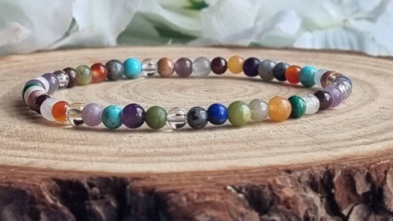 May include: A colorful beaded bracelet with various gemstones, including amethyst, turquoise, and carnelian.