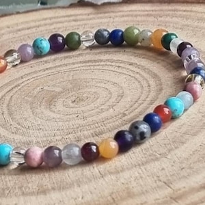 May include: A colorful beaded bracelet with a variety of stones, including amethyst, turquoise, and clear quartz.