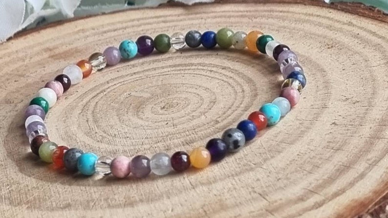 May include: A colorful beaded bracelet with a variety of stones, including amethyst, turquoise, and clear quartz.