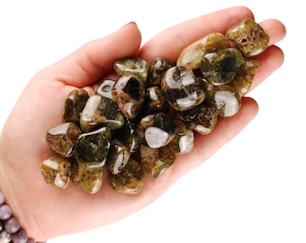 May include: A handful of green garnet tumbled stones. The stones are a mix of dark green and light green with a translucent quality.
