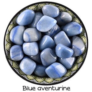 May include: A bowl filled with blue aventurine tumbled stones. The stones are smooth and have a light blue color with white streaks.
