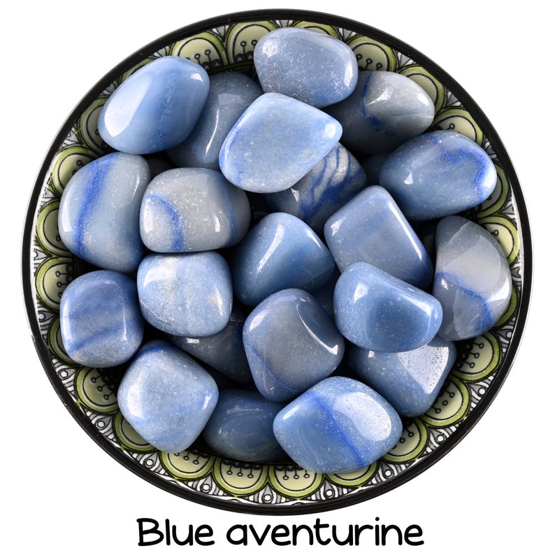 May include: A bowl filled with blue aventurine tumbled stones. The stones are smooth and have a light blue color with white streaks.