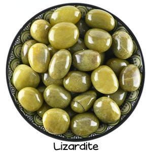 May include: A bowl filled with smooth, green Lizardite tumbled stones. The stones are a light green color and have a glossy finish.