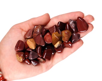May include: A collection of red, brown, and yellow tumbled stones. The stones are smooth and polished, and they have a variety of patterns and textures.