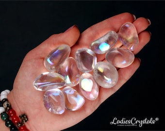 May include: A collection of iridescent clear quartz tumbled stones. The stones are smooth and have a rainbow sheen.
