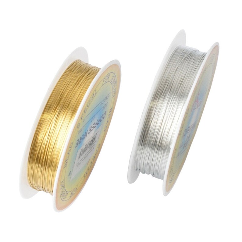 May include: Two spools of wire, one gold and one silver, on white spools with blue and gold labels. The labels read "Copper Wire 26 Gauge".