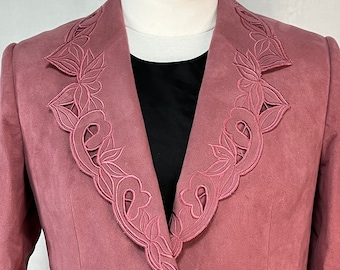 May include: A dusty rose blazer with a decorative floral embroidered collar.