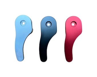 May include: Three metal levers in different colors: light blue, black, and red. Each lever has a rounded shape with a hole in the center.
