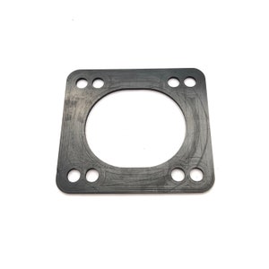 May include: A black rubber gasket with a circular opening and six evenly spaced holes around the perimeter.