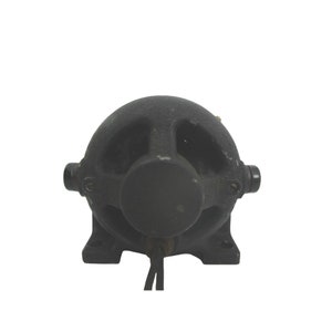 May include: A black cast iron electric motor with a round housing and three ventilation holes. The motor has a black cord attached to it.