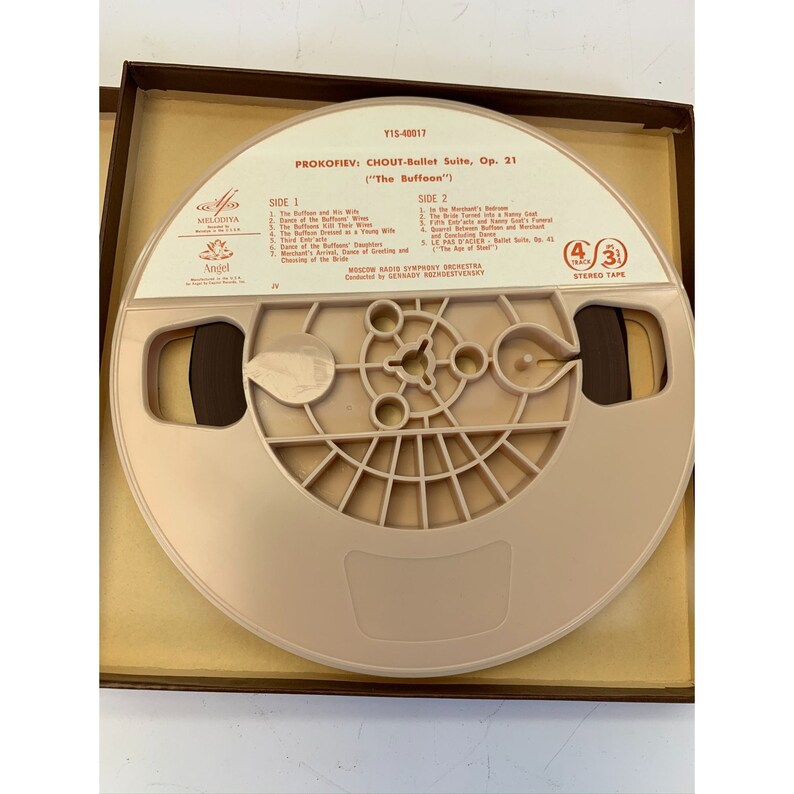 May include: A brown reel-to-reel tape cassette in a brown box. The cassette is labelled with the title "Prokofiev: Chout-Ballet Suite, Op. 21 (The Buffoon)". The cassette is labelled with the title "Prokofiev: Chout-Ballet Suite, Op. 21 (The Buffoon)".
