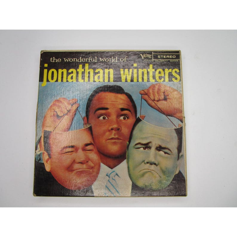 May include: A vintage record album cover featuring a man holding up three masks. The album is titled "the wonderful world of jonathan winters" and is a "Vogue Celebrity Series" record.